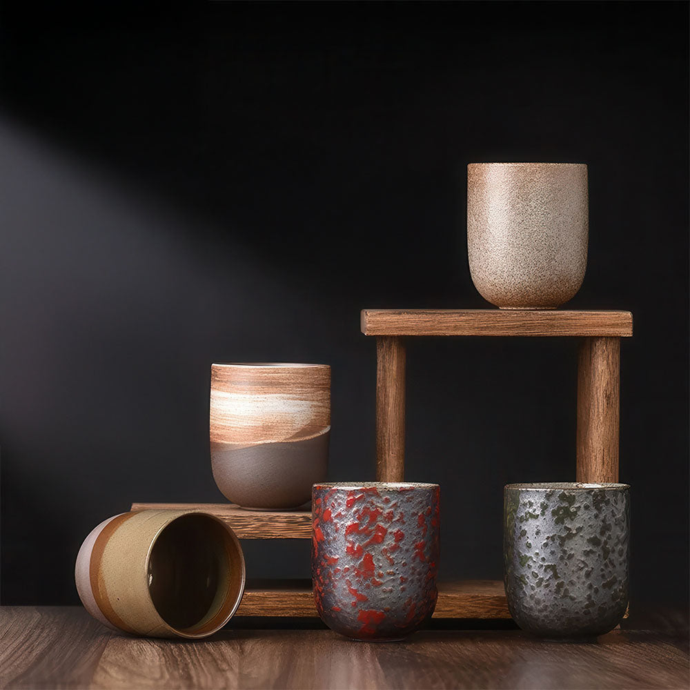 Présentation des différents modèles de tasses à thé artisanales sur des supports en bois