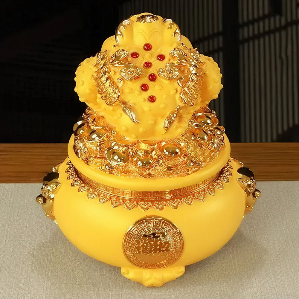 La tirelire porte bonheur chinois en résine jaune, représentant le crapaud de la fortune.